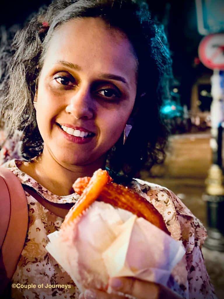 Vrushali eating a Halka outside a sweet shop in Istanbul