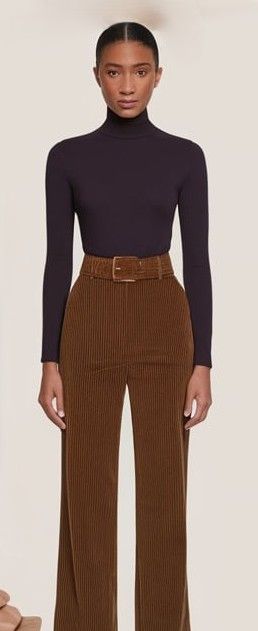 High-waisted brown corduroy pants paired with a fitted black turtleneck, offering a sleek and cozy Munich travel outfit for exploring in cooler seasons.