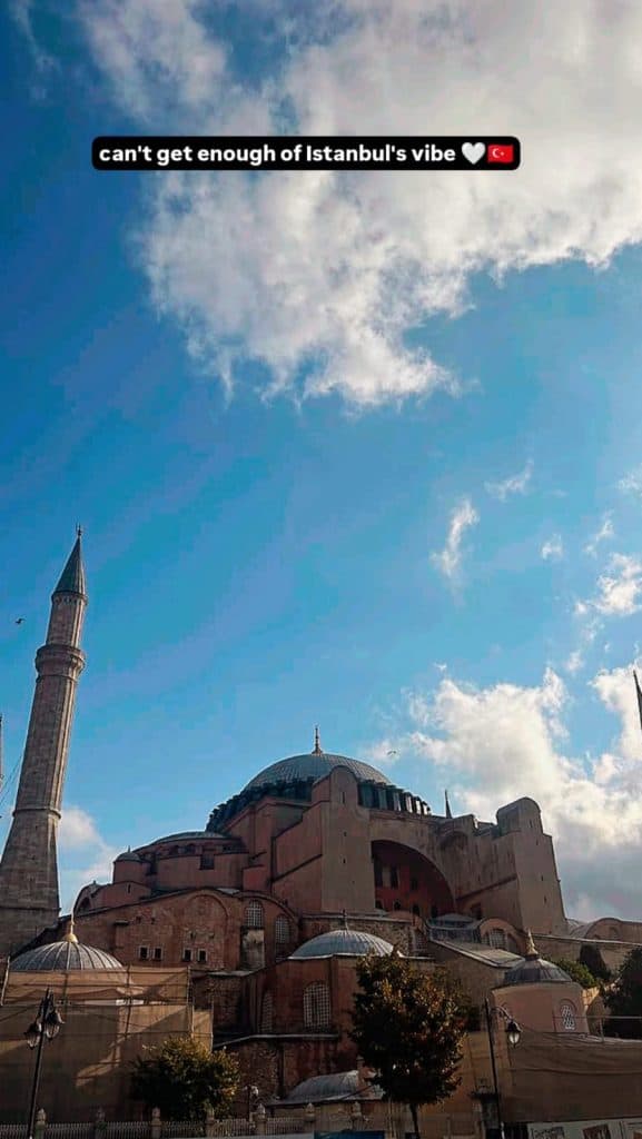  A stunning view of the Hagia Sophia in Istanbul under a bright blue sky with scattered clouds, featured in an Istanbul Instagram story with the text "can’t get enough of Istanbul’s vibe" at the top.