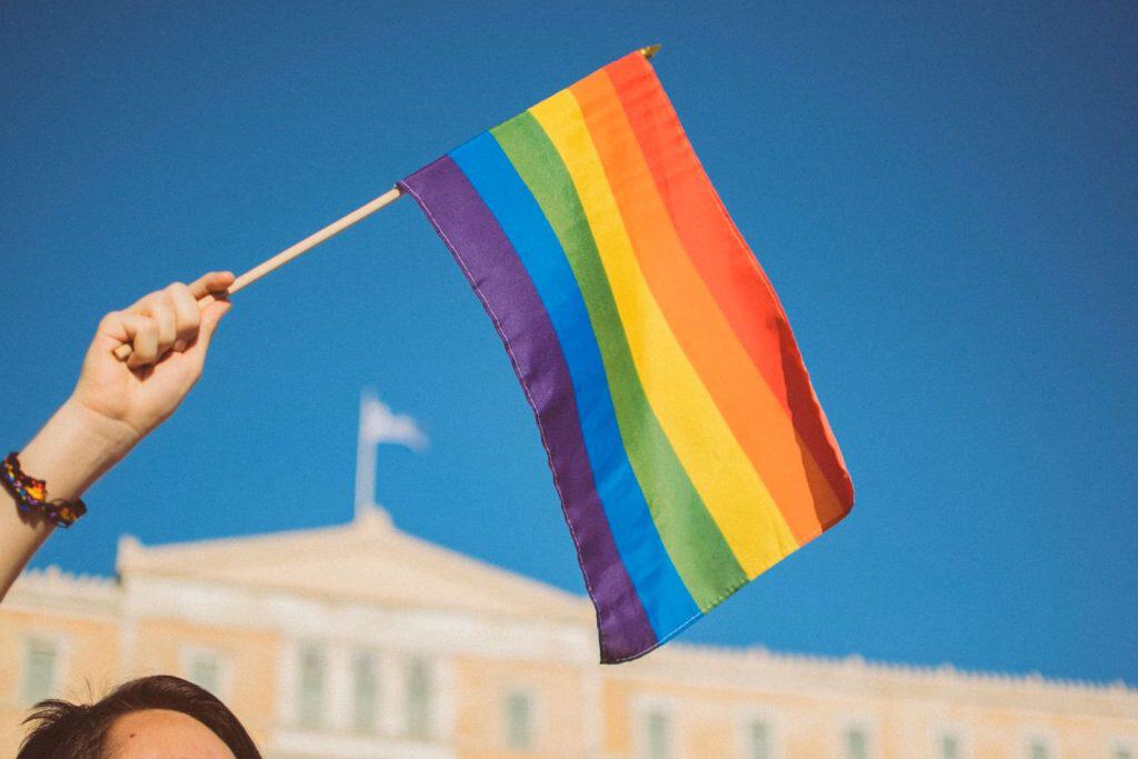 A person waving the Pride flag