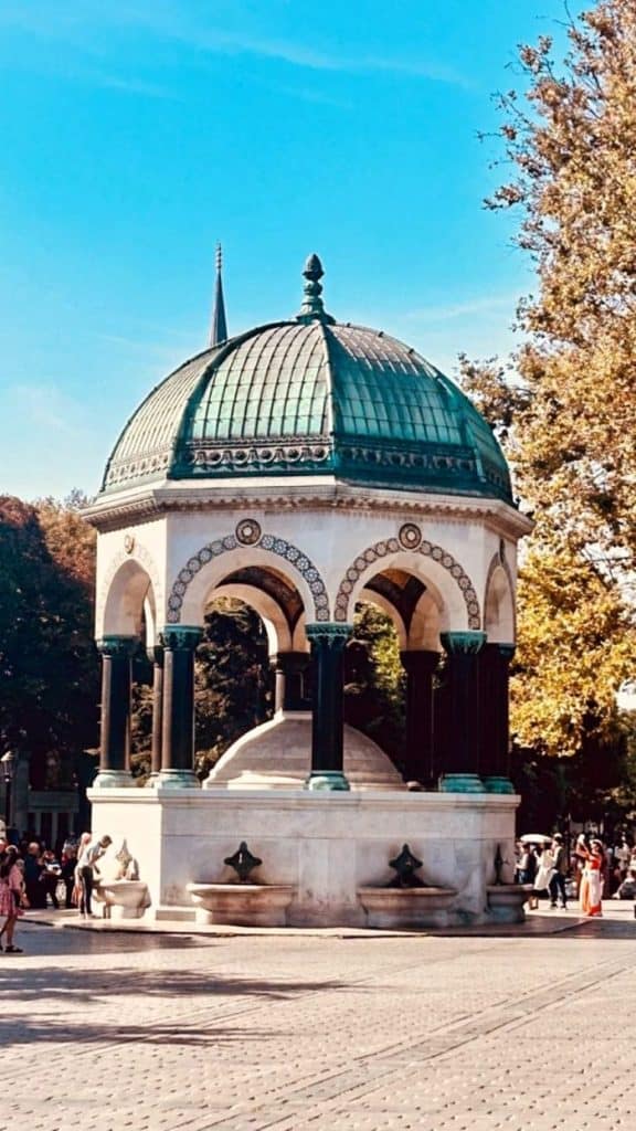 The German Fountain in Istanbul, with its elegant dome and surrounding greenery under a clear blue sky. A perfect cultural landmark for an Istanbul Instagram story.