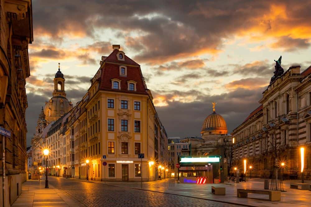 The old town of Dresden at sunset, glowing with warm light over Baroque buildings and cobblestone streets—an unforgettable experience for couples exploring honeymoon destinations in Germany with cultural charm