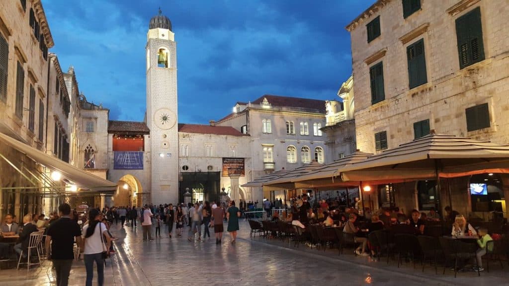 Dubrovnik’s famous Stradun street comes to life in the evening, with people dining at outdoor cafés under historic stone buildings. This charming pedestrian street is an essential experience on a Croatia Summer Itinerary.